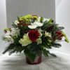 Christmas metal container filled with mixed pine and fresh flowers 