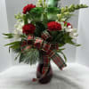 Red vase filled with mixed pine, fresh flowers and plaid bow