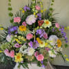 Large mixed floral spray with pink, yellow, purple, and white blooms