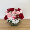 Cube arrangement with white hydrangea, red roses, pink roses, pink spray roses