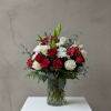 Red and white flower bouquet in a clear glass vase