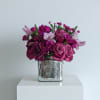 A rich and elegant blend of plum, magenta, and lavender blooms arranged