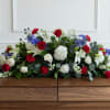 This luxurious spray showcases premium red and white roses, white hydrangeas, lilies