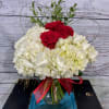 Beautiful white hydrangeas embracing red roses with heart