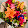 Colorful bouquet with roses, lilies, and mixed blooms wrapped in brown paper