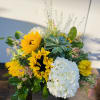 Sunflowers and white hydrangea in a low arrangement with succulents