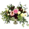 Wedding bouquet with pink, cream, and burgundy flowers in a glass compote vase