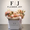 Pink and cream bouquet in a white gift box with ribbon