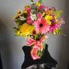 Colorful mixed bouquet in a glass vase with a pink plaid ribbon