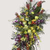 Bright and lush orchid standing spray for Celebration of Life or other