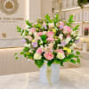 Pastel rose bouquet in a white hatbox with a ribbon