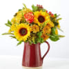 Sunflower and rose bouquet in a red ceramic pitcher