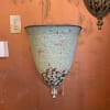 Rustic metal wall planter mounted on an orange wall