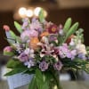 Mixed bouquet of pastel flowers in a glass vase