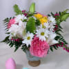Pink and white flower arrangement with daisies and roses in a vase