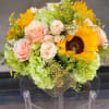 Bright mixed bouquet with sunflowers, peach/blush roses and pale green hydrangeas with