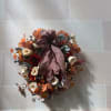 Autumn floral wreath with cream roses and a plaid ribbon bow