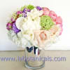 Bouquet of white, pink, and purple flowers in a clear glass vase