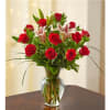12 Long stemmed Roses arranged with greenery and fresh lilies. Perfect to
