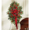 Standing red floral spray beside a casket