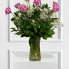 Vivid lavender roses form a beautiful bouquet designed to make the person
