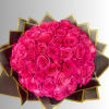 Round bouquet of bright pink roses wrapped in dark paper with gold trim