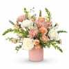 Pink and white floral arrangement in a blush vase