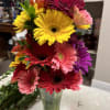 Bright gerbera daisy bouquet in a clear glass vase