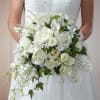 Bride holding a white bouquet of roses, calla lilies, and orchids