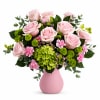 Pink roses and green flowers arranged in a pink vase