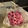 Bouquet of pink roses wrapped in pale paper