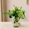 Green hydrangea and tulip arrangement in a clear glass vase