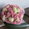 Large pink and white bouquet with roses and hydrangeas wrapped in pink paper