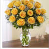 Yellow roses arranged in a clear glass vase