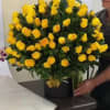 Large bouquet of yellow roses in a black box vase