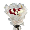 Bouquet of red and white roses wrapped in white paper with gold accents