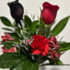 Red roses and carnations with greenery in a bouquet