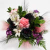 Bouquet of pink, white, purple, and black flowers with feathery accents
