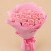 Bouquet of pink roses wrapped in pink paper with a satin ribbon