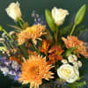 Mixed bouquet with orange chrysanthemums, white roses, and white lilies