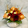 Autumn bouquet of roses and chrysanthemums in a white pumpkin vase