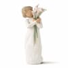 Figurine of a person in a white dress holding a bouquet of white calla lilies