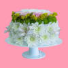 White and green floral arrangement on a pedestal stand with ribbon bows