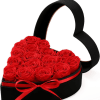 Heart-shaped box filled with red roses and tied with a red ribbon