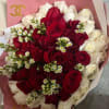 Bouquet of red and white roses wrapped in pink paper