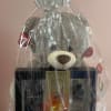 Gift basket with a teddy bear, cologne set, and heart-shaped chocolate box