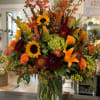 Bright sunflowers and orange lilies set a radiant, harvest-ready tone in this