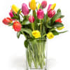 Colorful tulips arranged in a clear glass vase