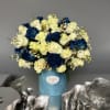 Blue and white rose bouquet in a light blue vase