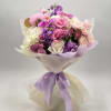 A hand-tied bouquet in soft lavender, blush pink, and creamy white tones